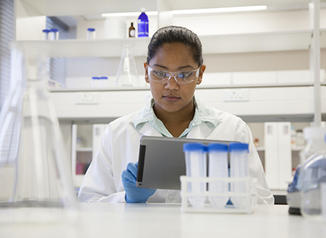 Mixed race scientist using digital tablet in laboratory